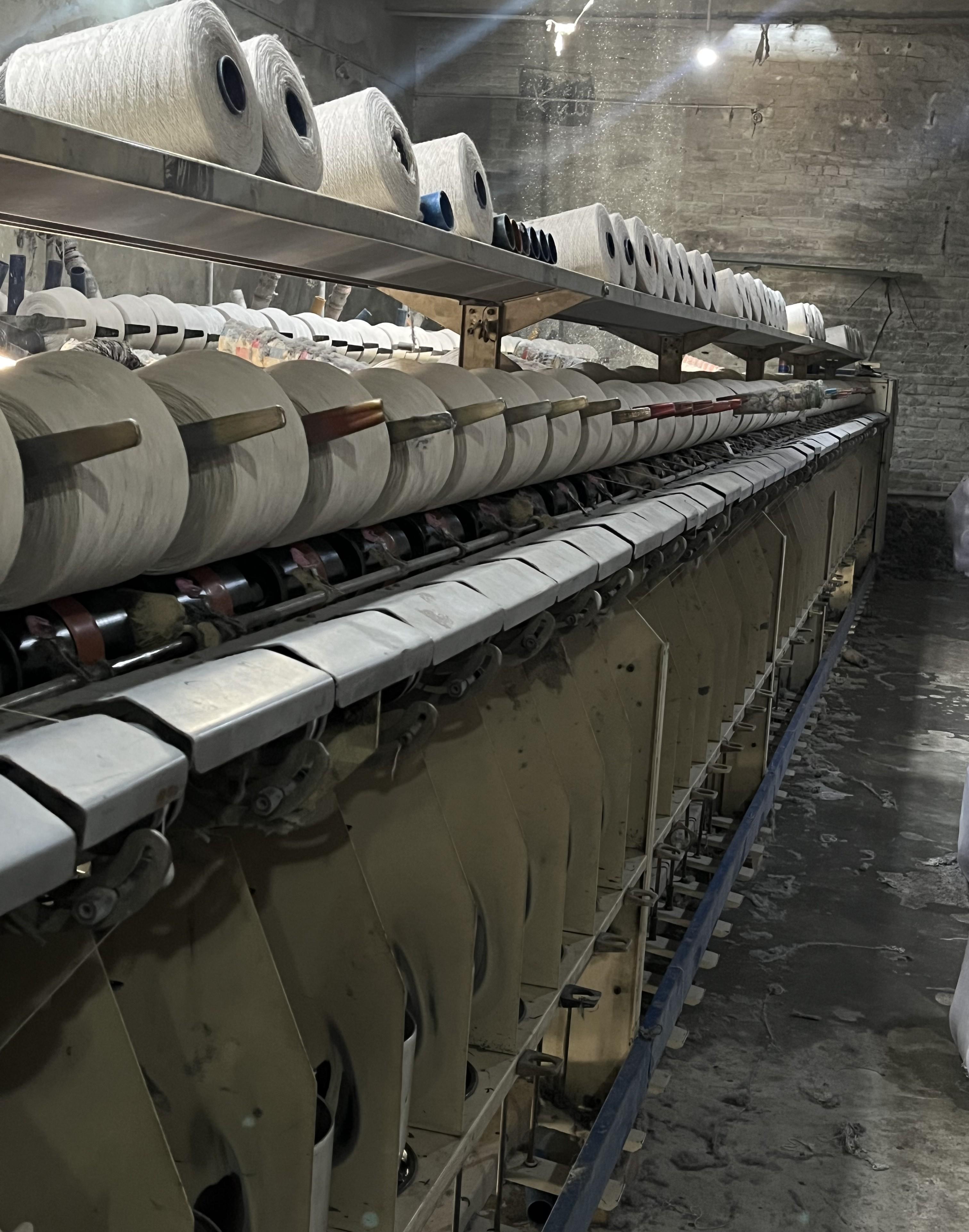 Yarn winding machine loaded with cotton cones at the Siraj Textile factory